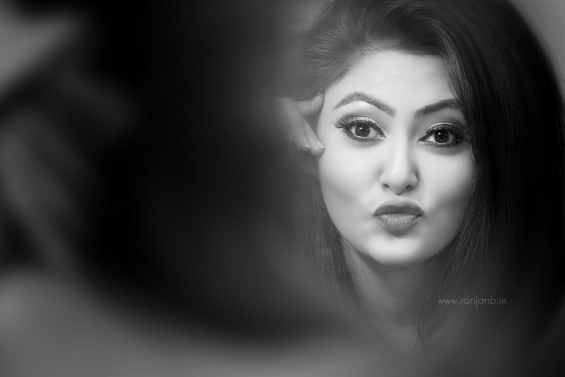 Black-and-white portrait of Indian model Megha captured by Ranjan Bhattacharya, showcasing her expressive look in a mirror reflection.