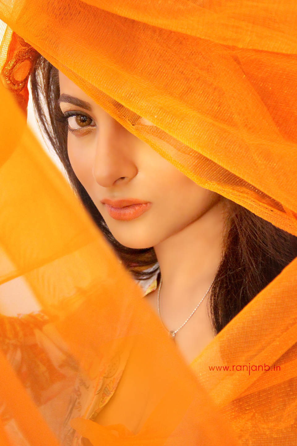 A Kolkata model in an elegant orange dress and veil, captured beautifully by photographer Ranjan Bhattacharya.