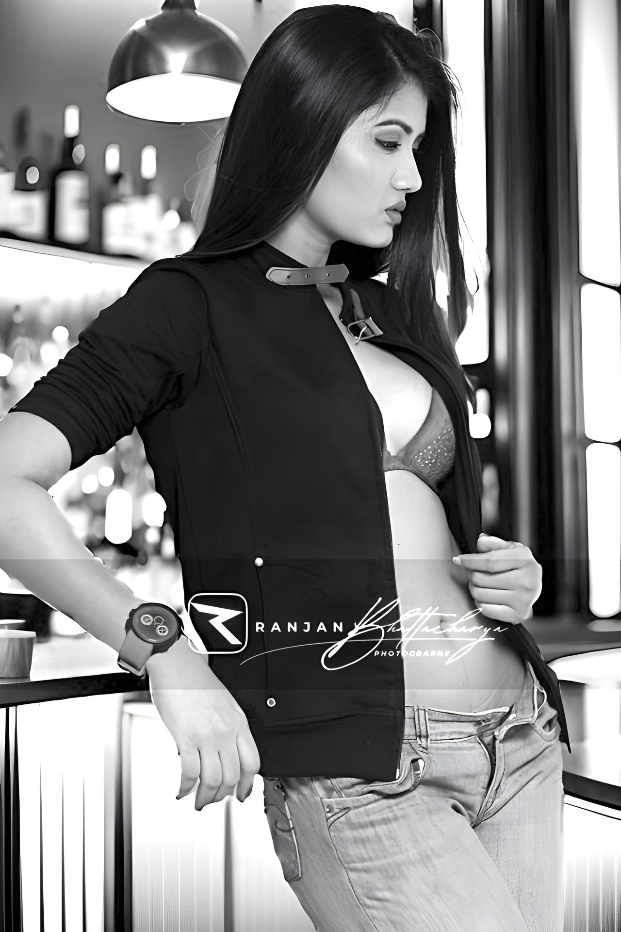 A Kolkata model, Manasi Dey, poses confidently in jeans and a jacket in front of a stylish bar, captured by Ranjan Bhattacharya.