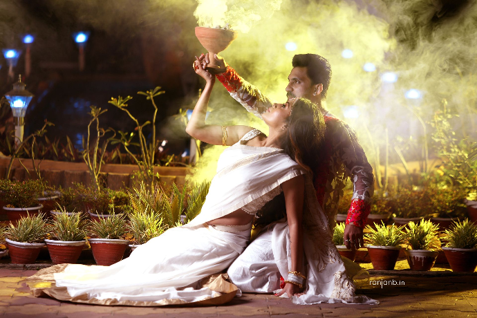 In a stunning display of tradition and romance, Tuban and Ankusree hold a pot symbolizing their shared future. This enchanting pre-wedding shoot, beautifully captured by Ranjan Bhattacharya, showcases the beauty of their love story.