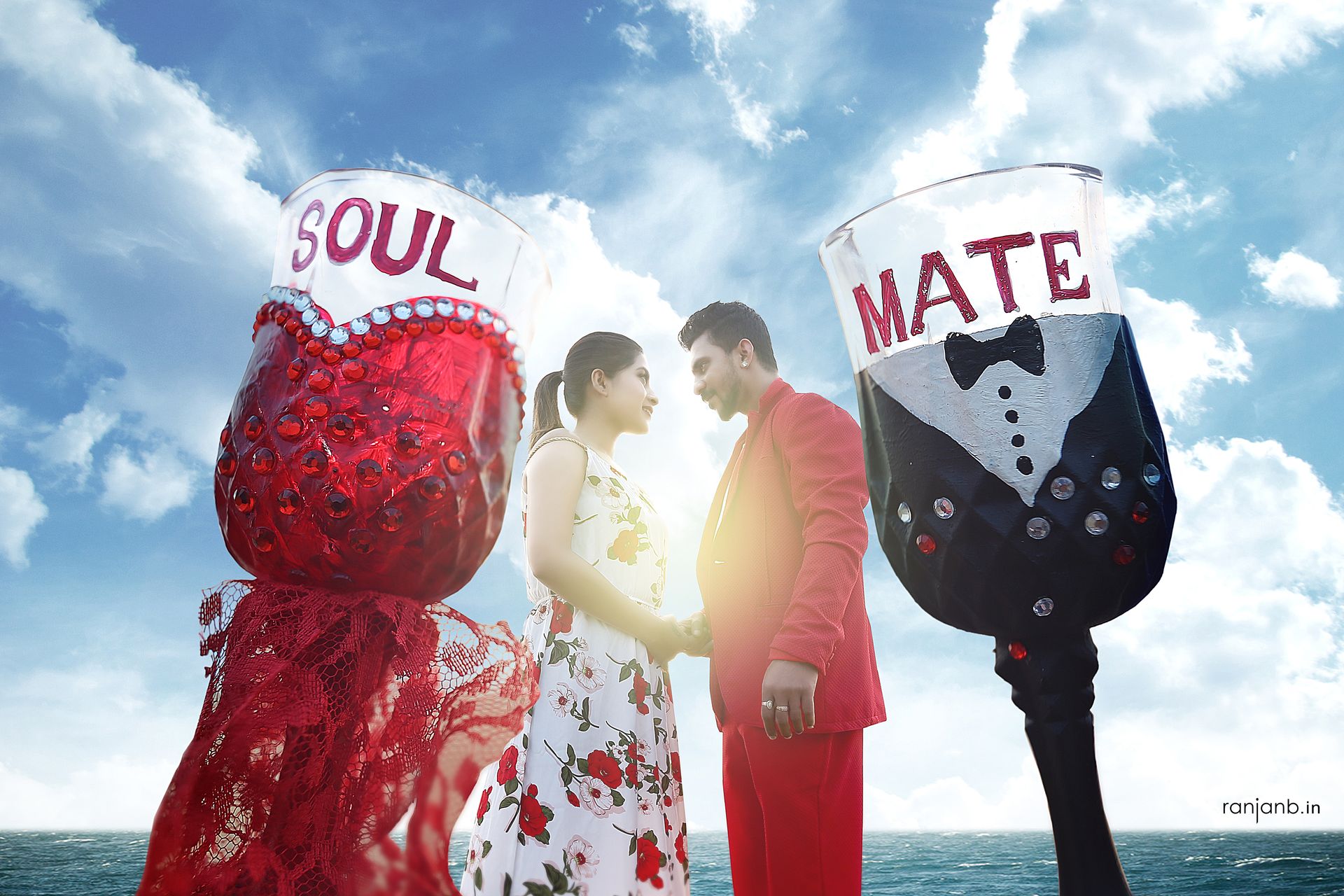 Stunning pre-wedding shoot featuring Tuban and Ankusree, adorned in red and white, perfectly complemented by a glass of wine. Photography by Ranjan Bhattacharya encapsulates their love story beautifully.