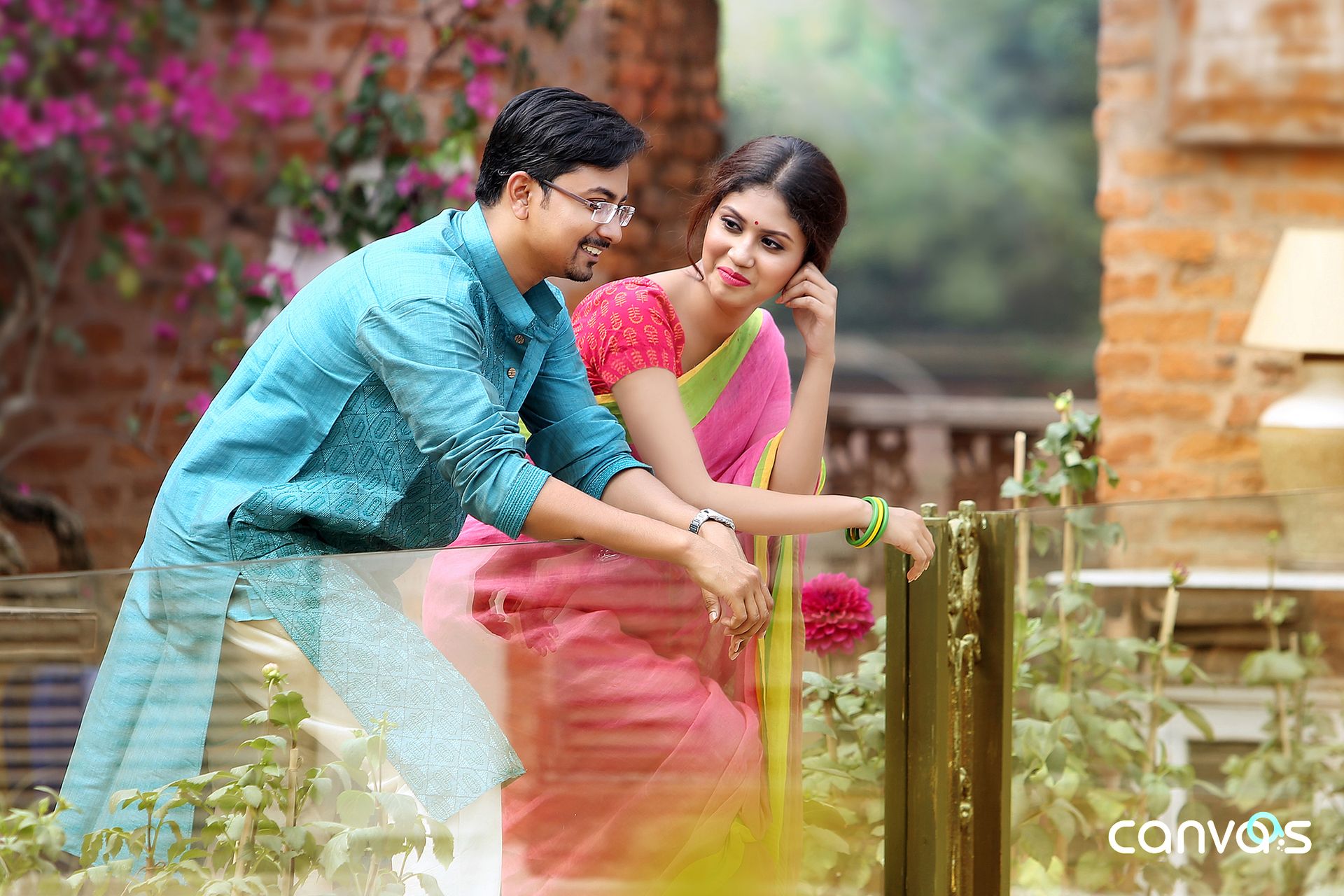 Candid shot of the bride and groom sharing a laugh during their wedding reception at Bawali Rajbari, Kolkata.