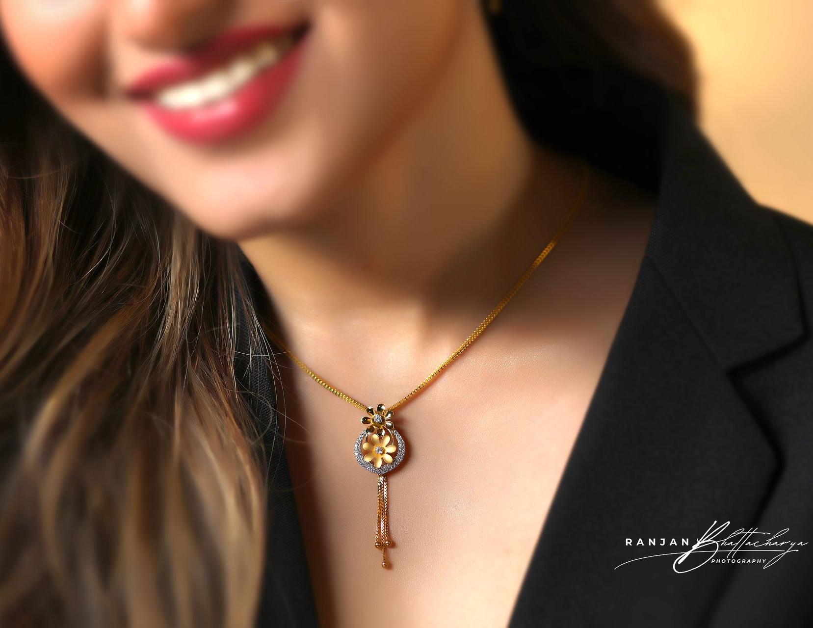 Close-up of a model wearing a trendy gold necklace with diamond pendant, photographed by Ranjan Bhattacharya.