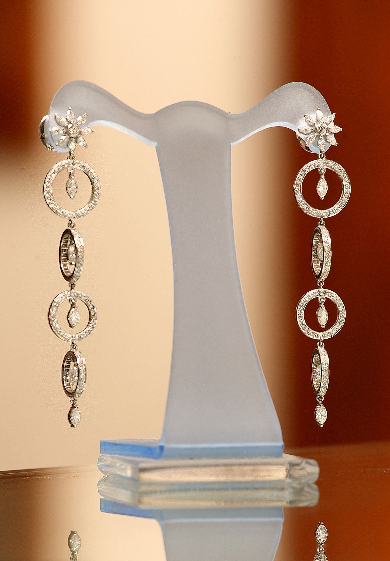 Detailed shot of earrings on a display stand, creative backdrop