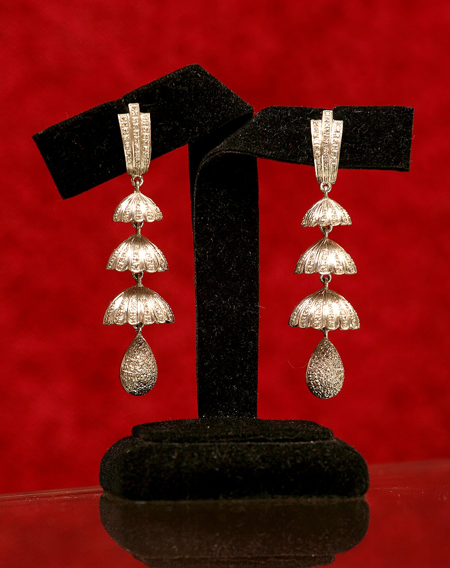 Detailed shot of earrings on a display stand, creative backdrop