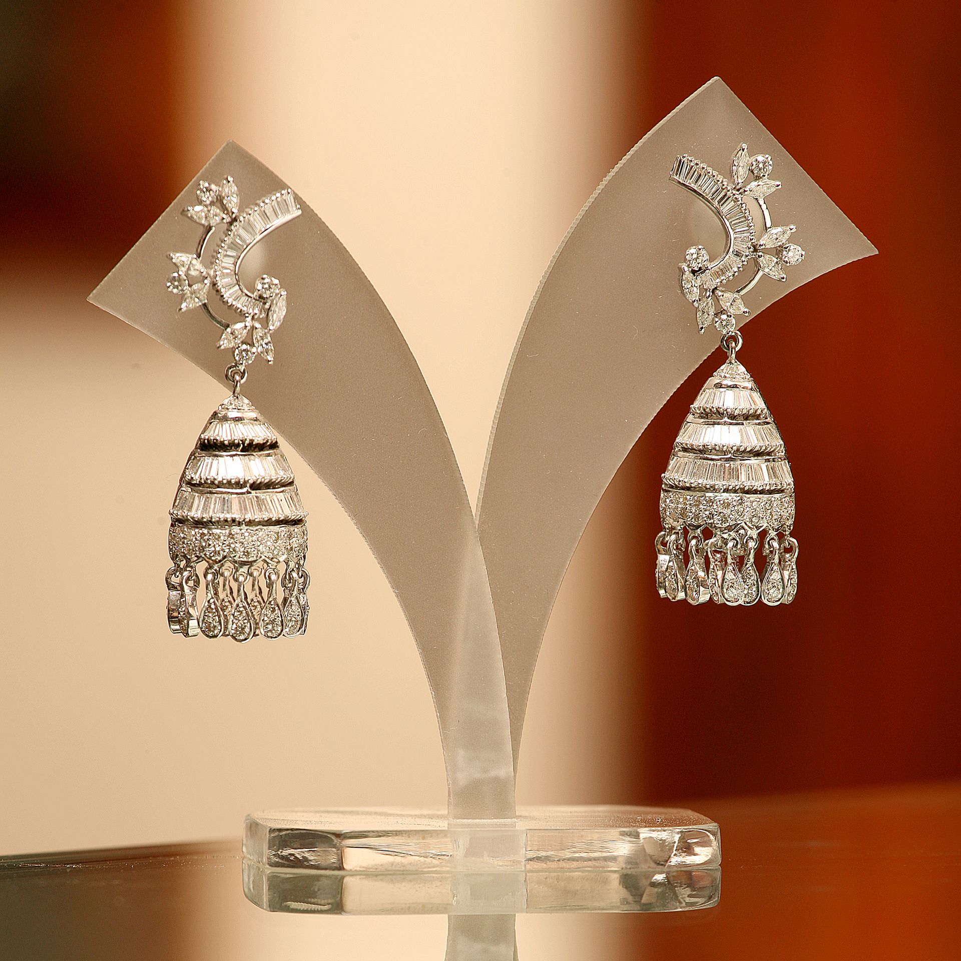 Detailed shot of earrings on a display stand, creative backdrop