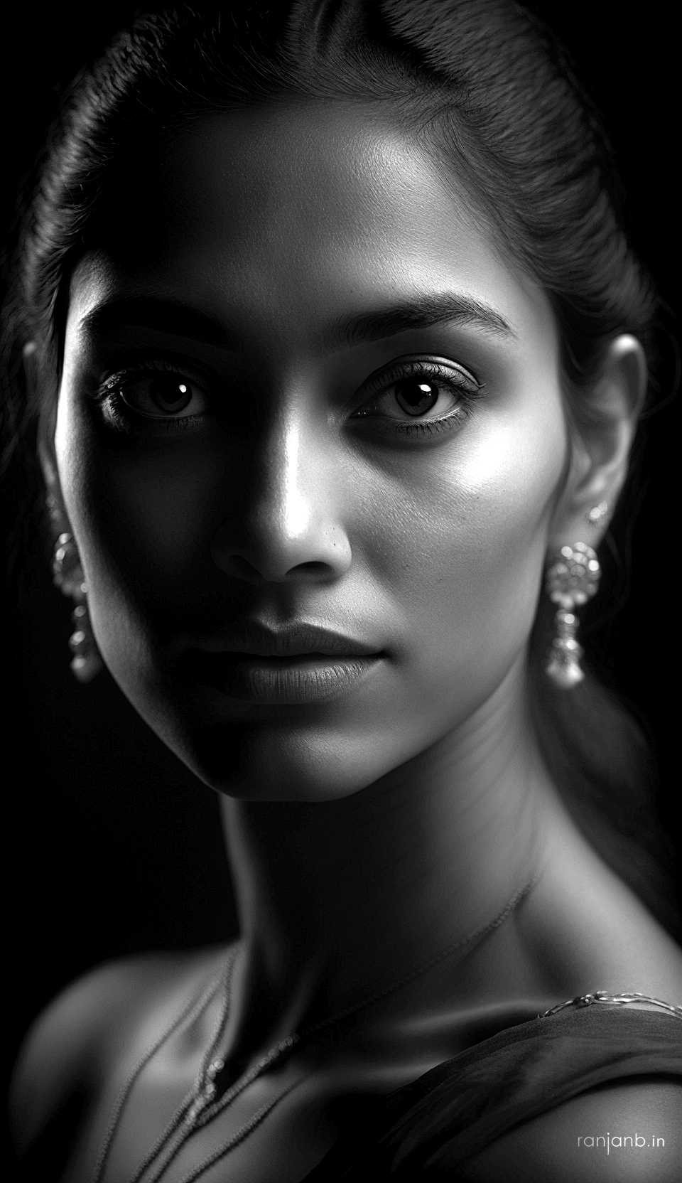 Black and white close-up portrait of a Mumbai model with traditional jewelry, captured by Ranjan Bhattacharya.