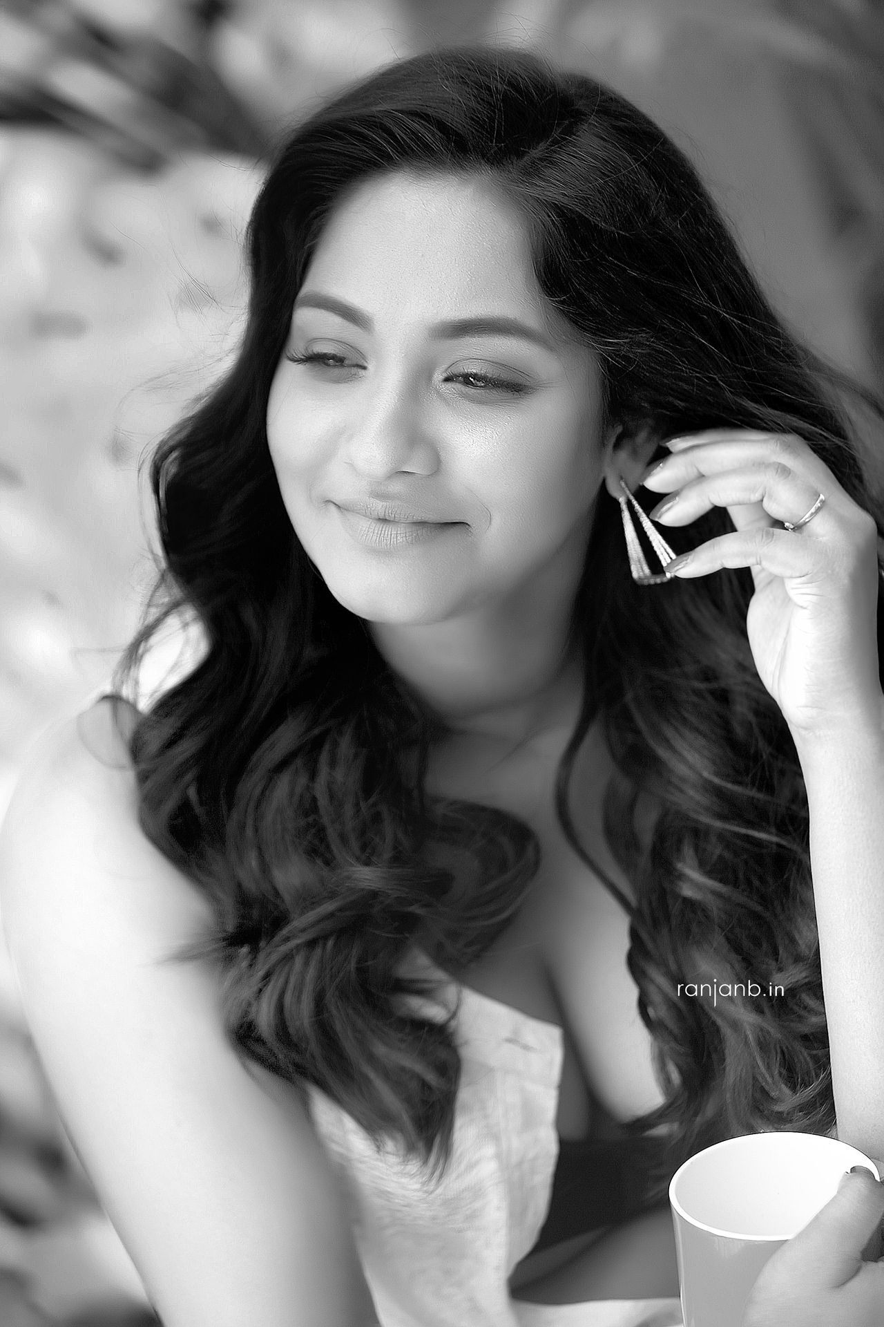 A close-up portrait of a woman in a casual outfit, highlighting her natural beauty, photographed by Ranjan Bhattacharya.