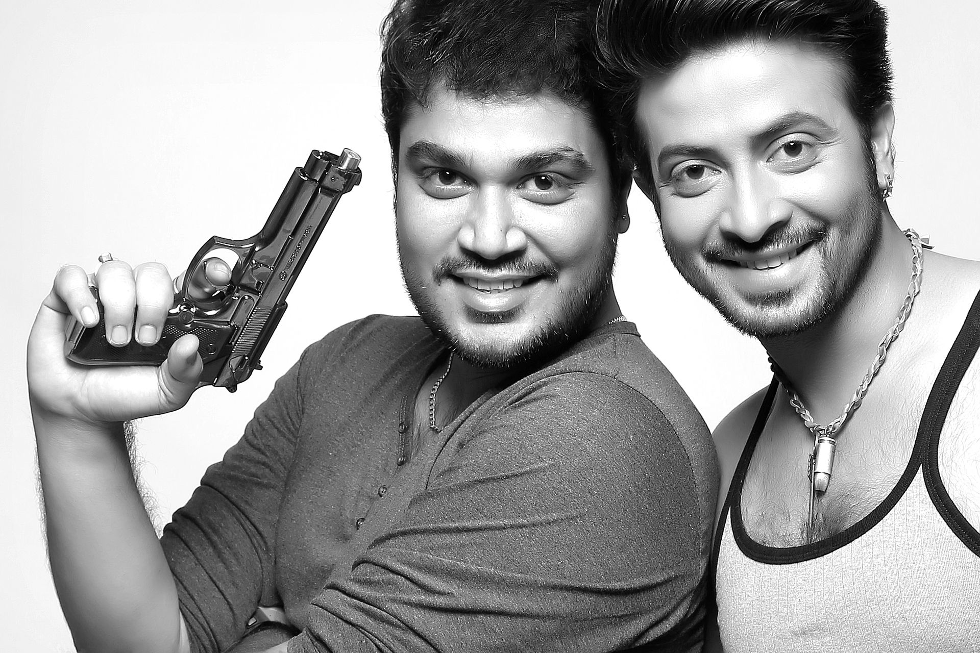 A professional studio portrait of photographer superstar Shakib Khan and Ranjan Bhattacharya, showcasing a fun expression with classic studio lighting.