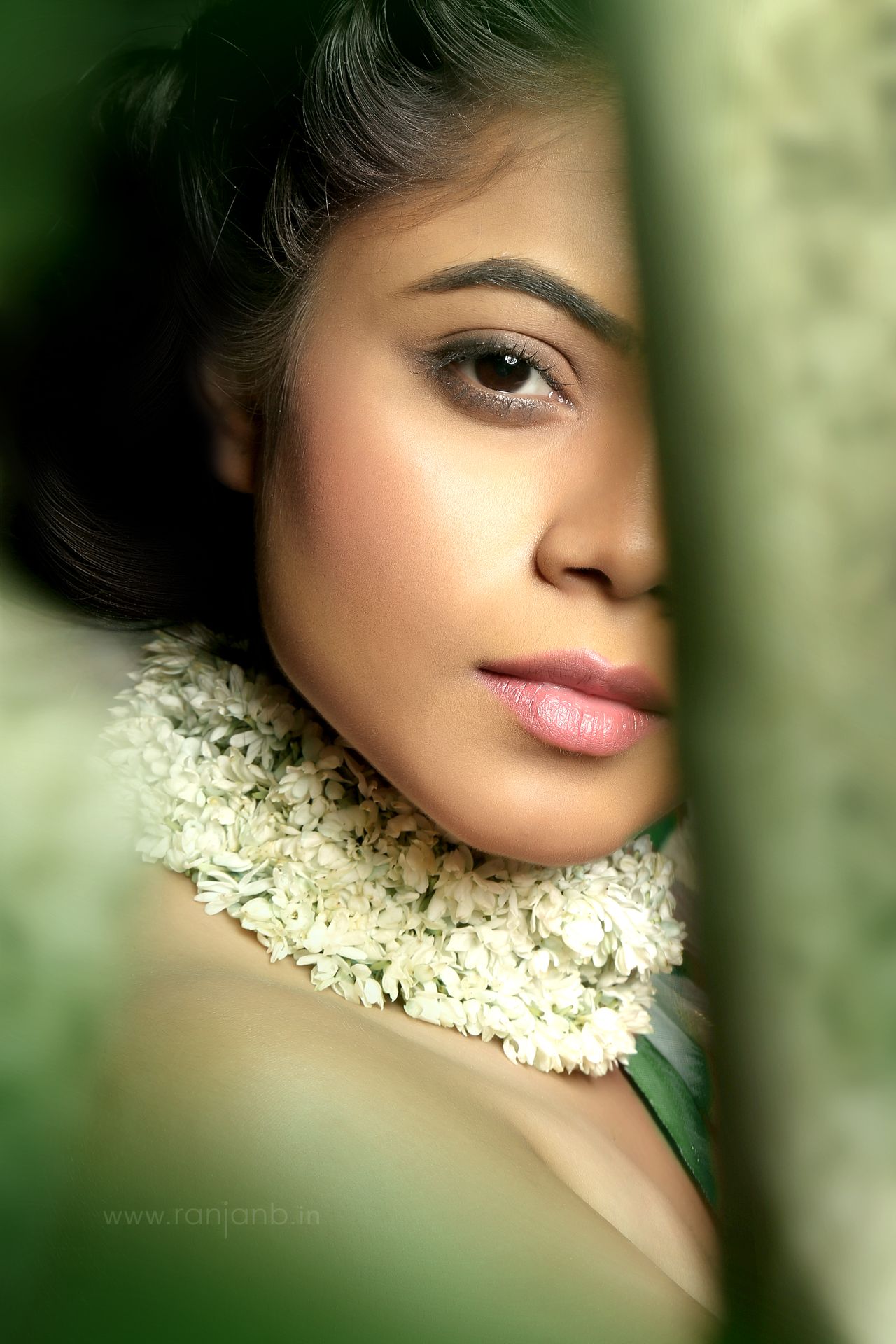 A close-up portrait of a model in a traditional saree, highlighting her natural beauty, photographed by Ranjan Bhattacharya.