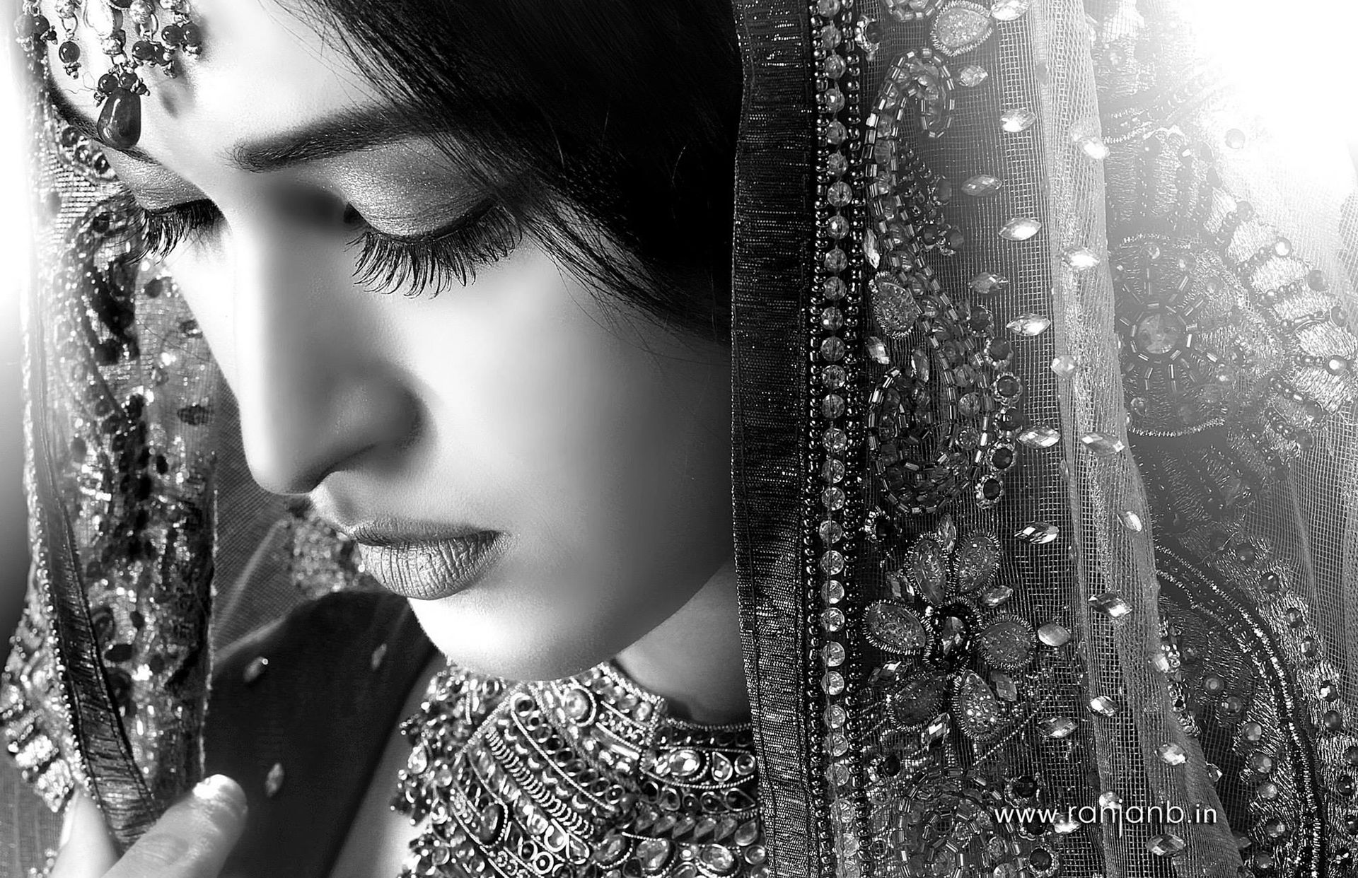 A close-up portrait of a woman in a traditional saree, highlighting her natural beauty, photographed by Ranjan Bhattacharya.