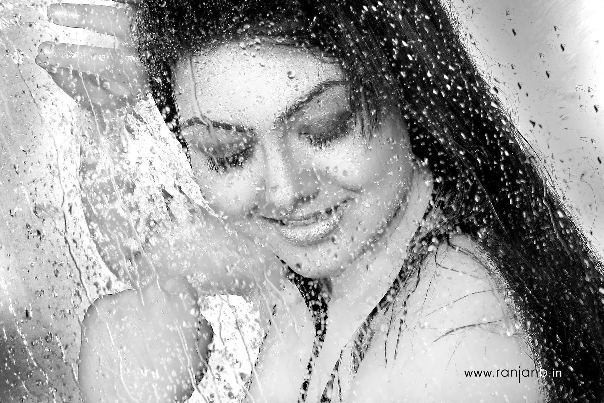 A close-up portrait of a woman in shower, highlighting her natural beauty, photographed by Ranjan Bhattacharya.