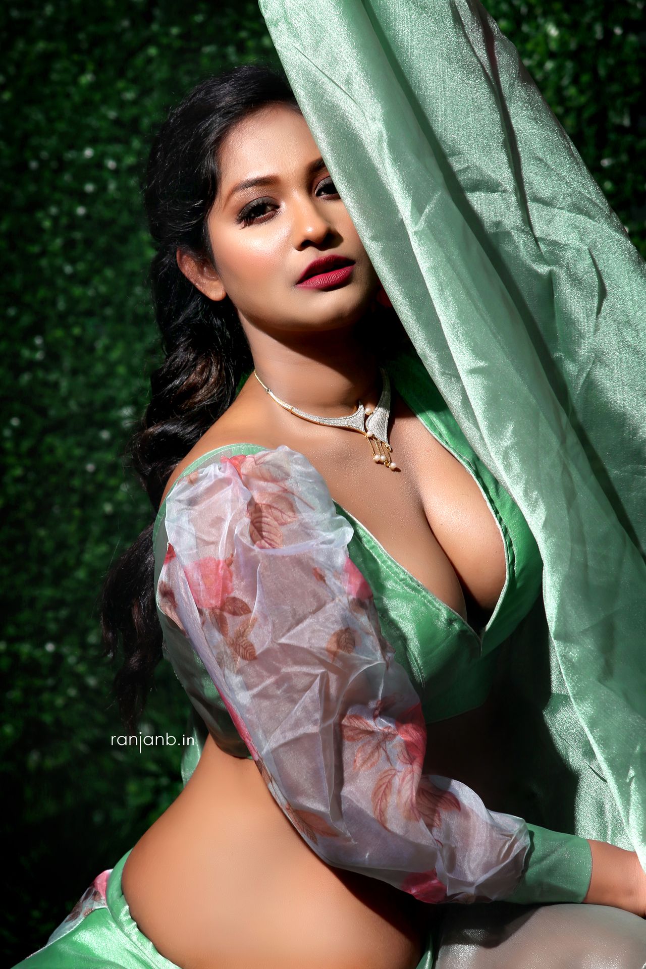 A striking portrait of Tania Guhathakurta, elegantly posed in a green outfit with floral sleeves, photographed by Ranjan Bhattacharya.