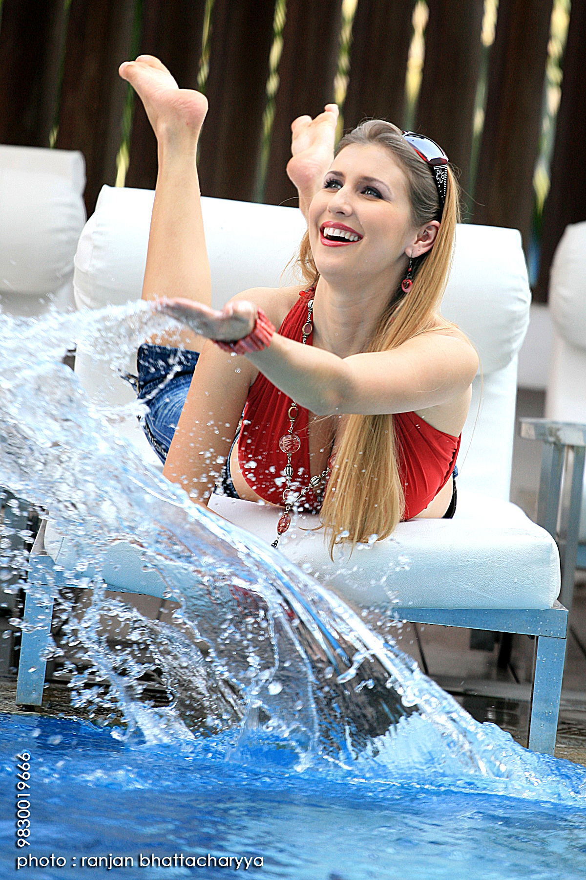 Playful elegance: Claudia Ciesla enjoying a refreshing splash by the pool, photography by Ranjan Bhattacharya