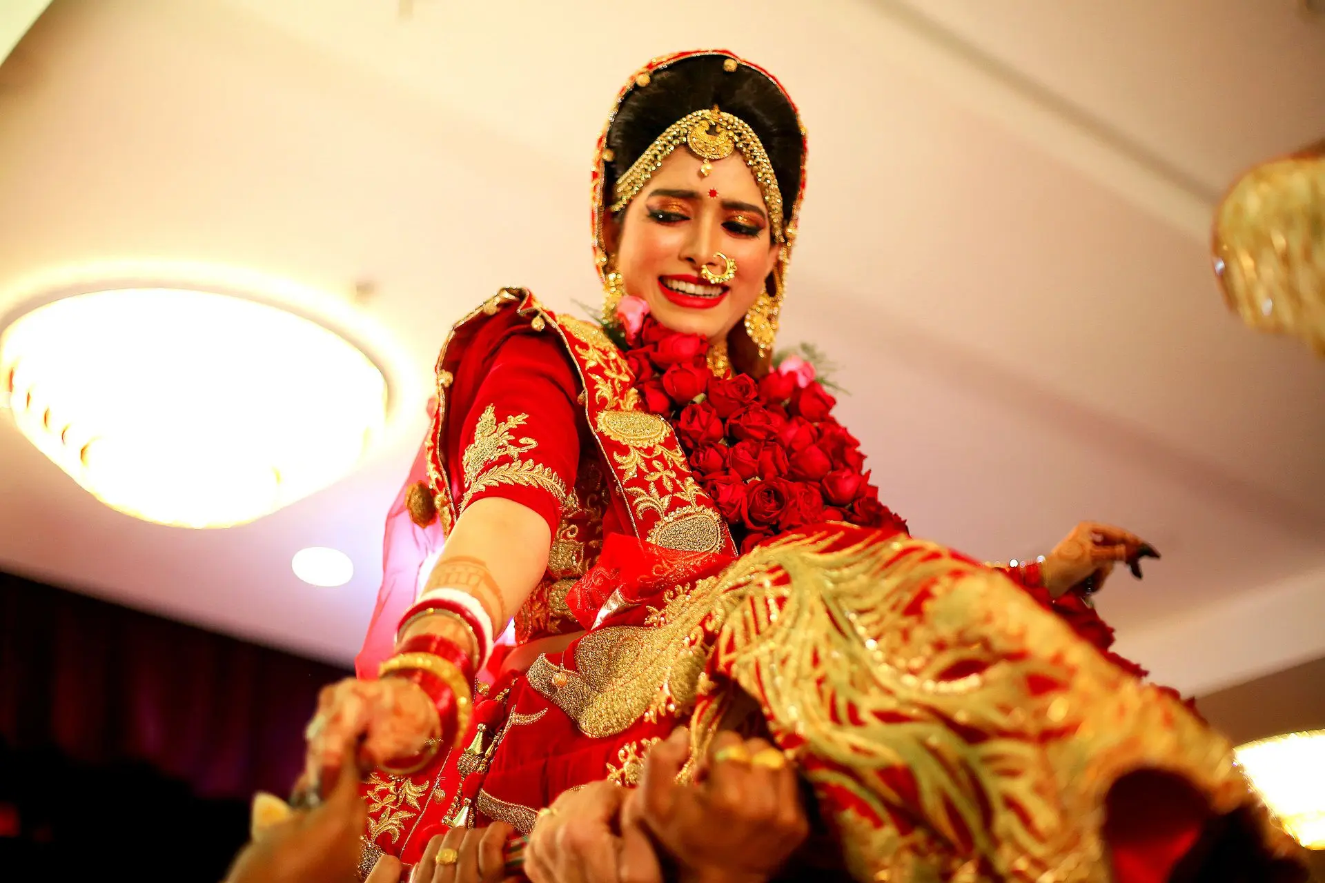 A joyful wedding moment where al guys lifts the Bride, captured by photographer Ranjan Bhattacharya.