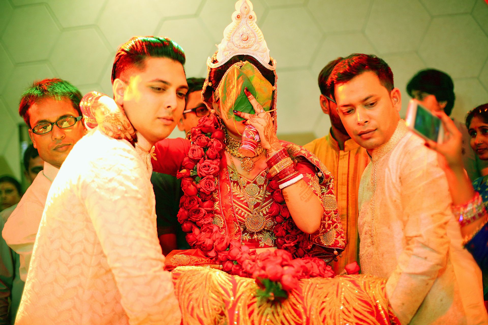 A joyful wedding moment where al guys lifts the Bride, captured by photographer Ranjan Bhattacharya.