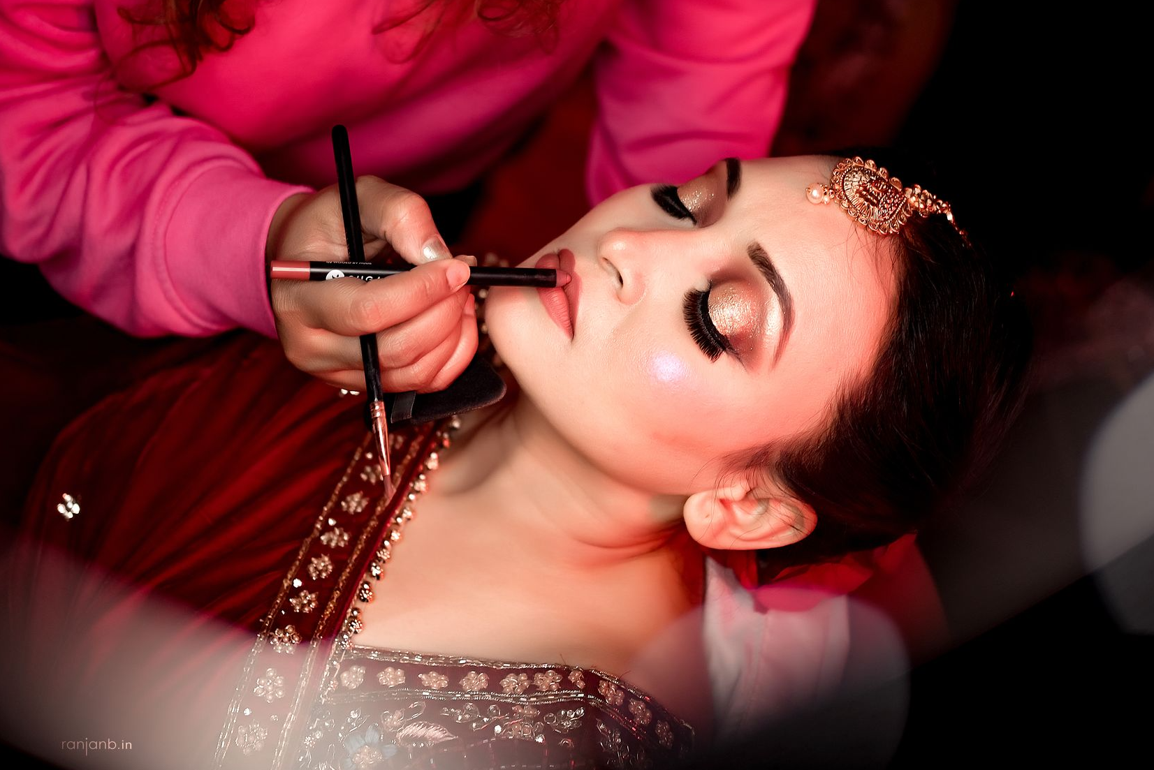 Makeup artist applying bridal makeup, highlighting flawless application for a makeup brand